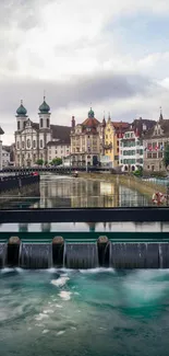 Scenic European river view with historic buildings and cloudy sky.
