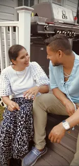 Couple sitting outdoors in cozy backyard setting.