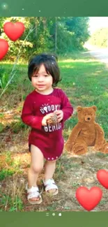 Toddler in red dress with teddy bear and heart icons on green background.