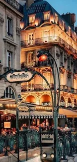 Evening view of Parisian street, glowing lights, and historic architecture.