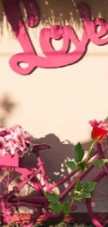 Pink bicycle with flowers and a love sign creating a romantic ambience.