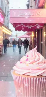 A charming pink frosted cupcake with sparkling decor on a cozy street.