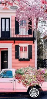 Pink truck with flowers in front of a matching house.