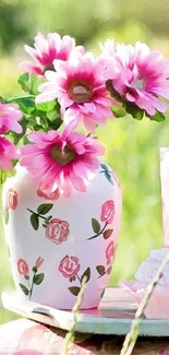 Pink flowers in a beautifully decorated vase in a natural background.