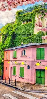 A picturesque Paris street with a pink building, ivy, and cherry blossoms.