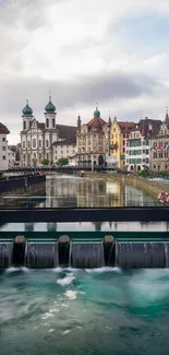 Riverside cityscape with historic buildings and a serene river view, ideal for mobile wallpaper.