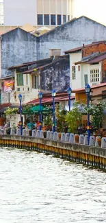 Charming riverside street with colorful houses and serene water.