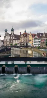 Picturesque town by a river with vibrant buildings and sky reflection.