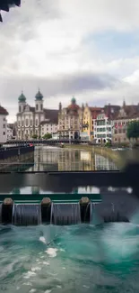 Serene riverside townscape with historic buildings and water reflections.