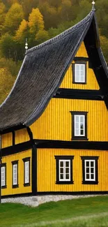 Charming rustic yellow cottage surrounded by autumn trees.