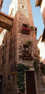 Charming rustic stone tower wallpaper with flowers.