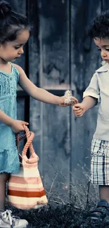 Two children holding hands in a rustic, blue background.