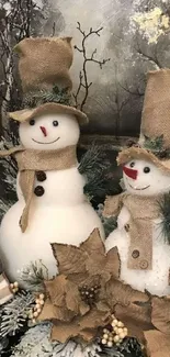 Two snowmen in burlap hats with a winter forest background.