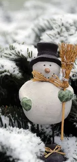 Charming snowman with broom in a snowy winter scene.