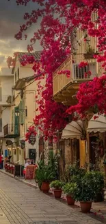 Charming European street with pink flowers under a sunset sky.