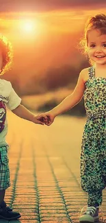 Two kids holding hands at sunset, smiling joyfully.