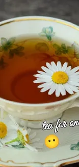 Charming tea cup with daisy and floral design on wooden bench.