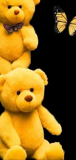 Yellow teddy bears with butterfly on black background.