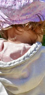 Cute toddler wearing pink hat outdoor.