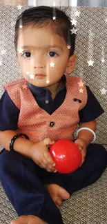 Toddler with red ball and digital stars on couch.