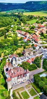 Aerial view of a charming village surrounded by lush green landscape.