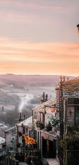 Charming village street at sunset with rustic buildings and scenic landscape.