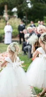 Flower girls walk down a petal-lined wedding aisle.