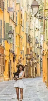 A woman in a sundress on a vibrant yellow European street.