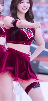 Smiling dancer in maroon costume performing energetically.