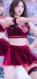 Two dancers in maroon performing energetically.