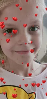 Smiling child with red hearts overlay.