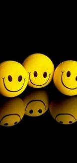 Three yellow smiley faces on black background.