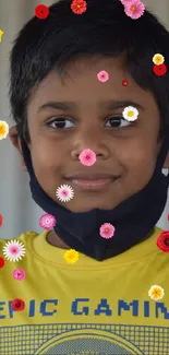 Child in yellow T-shirt smiling with thumbs up.