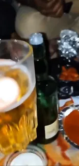 Person holding glass of beer at a casual gathering.