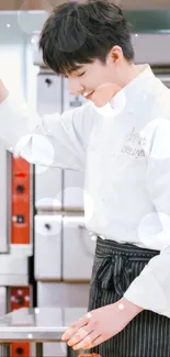 Chef in white uniform preparing food in a kitchen.