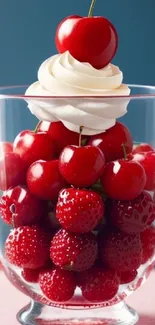 A glass filled with ripe cherries topped with a swirl of cream.