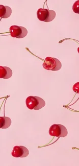 Vibrant cherries scattered on a pink background.