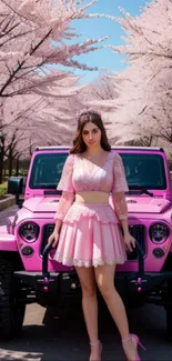 A stylish woman stands beside a pink car under cherry blossom trees.
