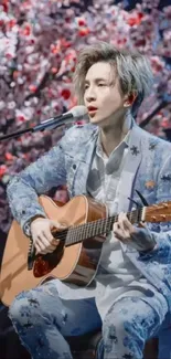 Musician playing guitar with cherry blossom backdrop in vivid detail.