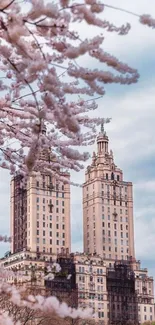 Cherry blossoms frame a stunning urban skyline on a bright day.