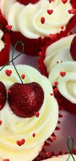 Cupcakes with creamy frosting and glittery red cherries on top.