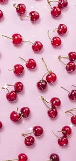 Mobile wallpaper with red cherries on pastel pink background.