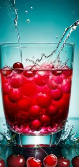 Refreshing cherry splash in a glass with aqua background.