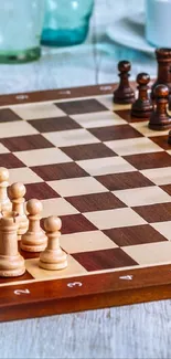 Chessboard setup on rustic wooden table.