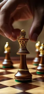 Close-up of a hand moving a queen on a chessboard.