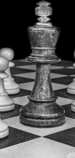 Black and white chess pieces on a chessboard wallpaper.