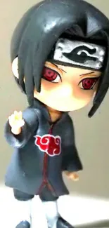 Chibi ninja figurine with red eyes and dark hair in a cartoon style.