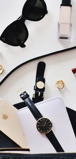 Chic accessory flat lay with watch, phone, sunglasses, and makeup items.