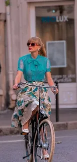 Stylish woman in teal blouse cycling in urban setting.