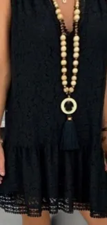 Chic black lace dress with beaded necklace.